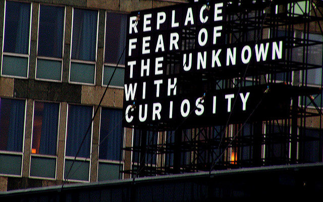Street sign saying 'replace fear of the unknown with curiosity' 3000222387_9ed2c02dc6_z